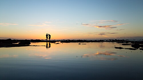 Two people silhouetted against a sunset